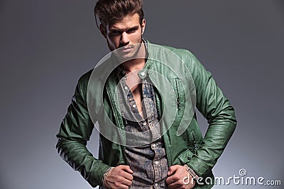 Casual fashion man pulling his leather jacket Stock Photo