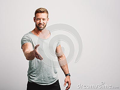 Casual handsome man giving hand offering handshake Stock Photo