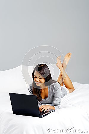 Casual laptop bedroom woman Stock Photo