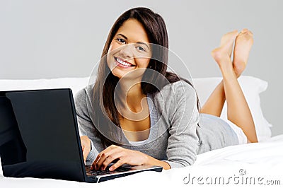 Casual laptop bedroom woman Stock Photo