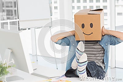 Casual man with happy smiley box over face at office Stock Photo