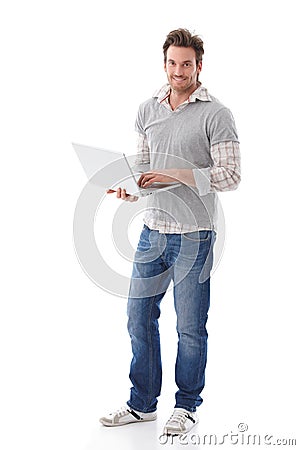 Casual man holding laptop smiling Stock Photo
