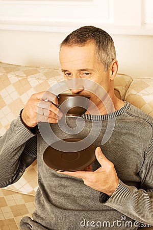 https://thumbs.dreamstime.com/x/casual-man-sitting-couch-drinking-coffee-mature-cup-51173214.jpg