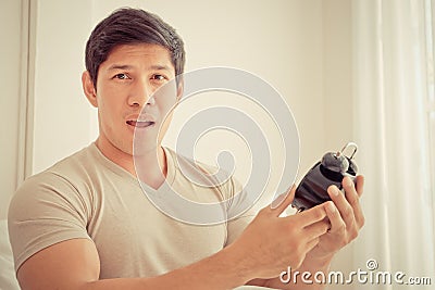 Casual man surprise on late alarm clock time Stock Photo