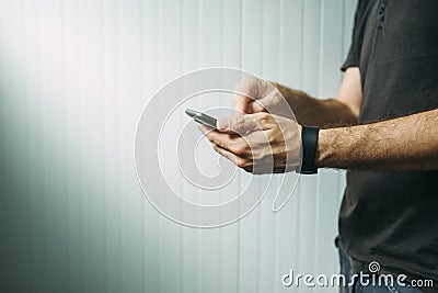 Casual man using smart phone to send text message Stock Photo