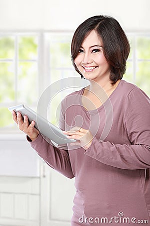 Casual middle aged Woman holding tablet computer Stock Photo