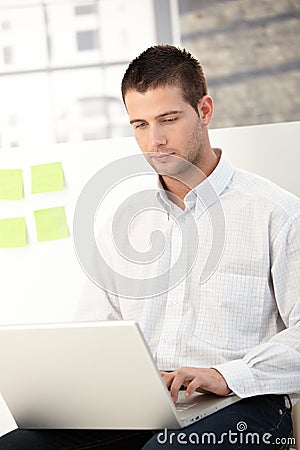 Casual office worker using laptop Stock Photo