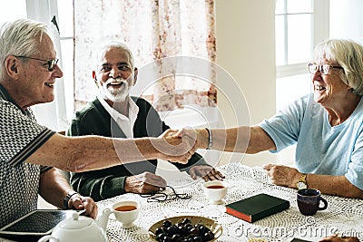 Casual seniors shaking hands refreshment Stock Photo