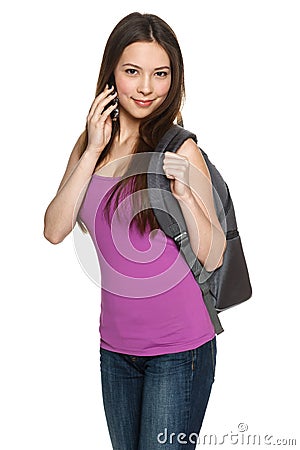 Casual teen girl wearing backpack talking on cell phone Stock Photo