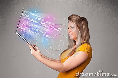 Casual woman holding laptop with exploding data and numers Stock Photo