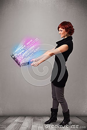 Casual woman holding laptop with exploding data and numers Stock Photo