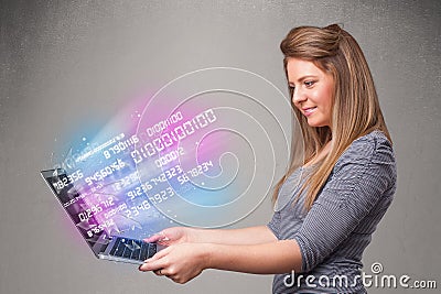 Casual woman holding laptop with exploding data and numers Stock Photo