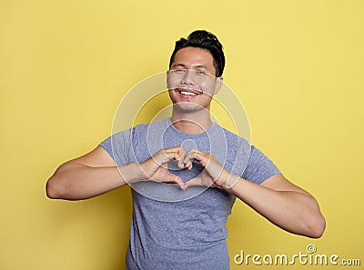 casual young man smile expression love sign with he hands Stock Photo