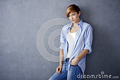 Casual young woman leaning to wall Stock Photo