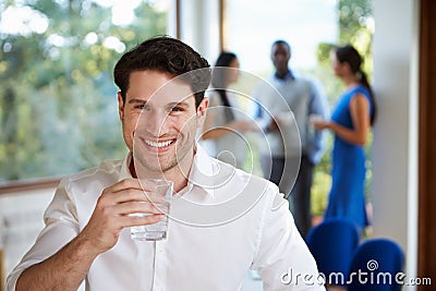 Casually Dressed Businessman At Meeting In Boardroom Stock Photo
