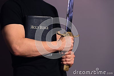 Young Athletic Man with His Bible and Sword Stock Photo