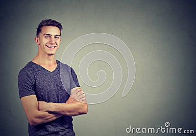 Casually handsome confident young man in t-shirt keeping arms crossed Stock Photo