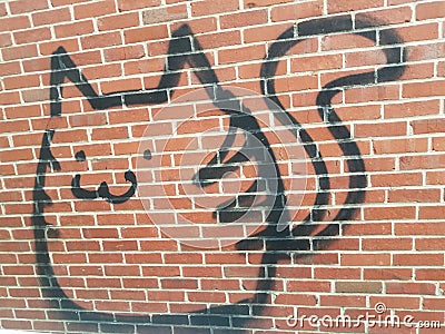 Cat or animal graffiti vandalism on red brick wall Editorial Stock Photo