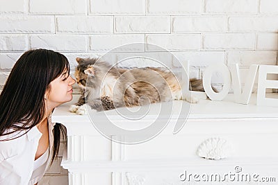 Cat and her young owner rubbing noses Stock Photo