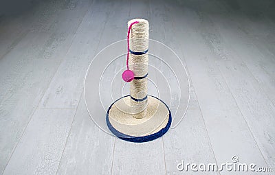  cat scratching post with ball toy on a wooden background. Stock Photo