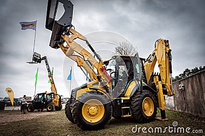 Cat tractors and other construction equipment at the public event of Riga Machinery Sales. Editorial Stock Photo