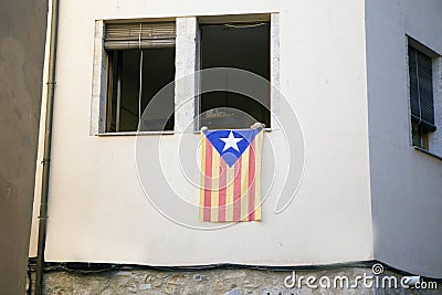 Catalan flag posted from the window of an apartment building in protest Editorial Stock Photo