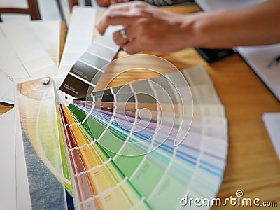 Catalogue of colour with hand of man selecting for interior design Editorial Stock Photo