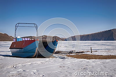 Catamaran on the snowy shores of lake Baikal Stock Photo