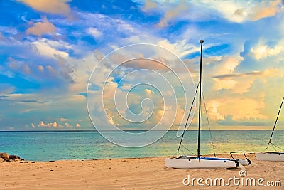 Catamaran on a tropical beach by the turquoise waters of the Car Stock Photo