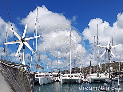 Catamarans and sailboats in the French West Indies marina. Marina in the caribbean under tropical blue sky. Close up of Stock Photo