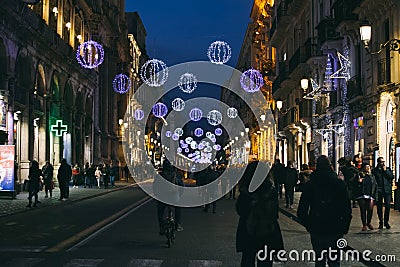 Busy Etnea street decorated with festive New Year illumination lights, Catania, Sicily Editorial Stock Photo