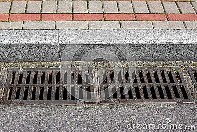 Catch basin grate of the lattice of the drain system for drainage of rainwater. Stock Photo