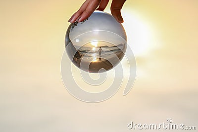 Catch the crystal ball with her finger Stock Photo