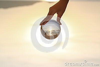 Catch the crystal ball with her finger Stock Photo