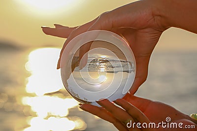 Catch the crystal ball with her finger Stock Photo