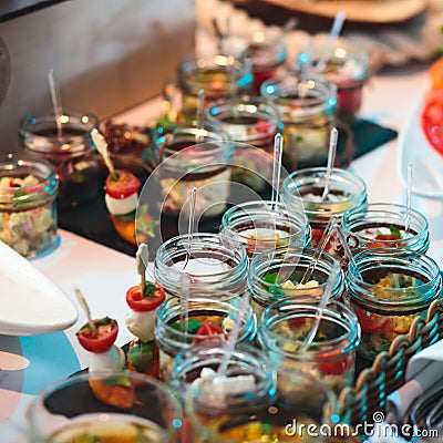 Catering banquet table with different food snacks and appetizers on corporate christmas birthday party event Stock Photo