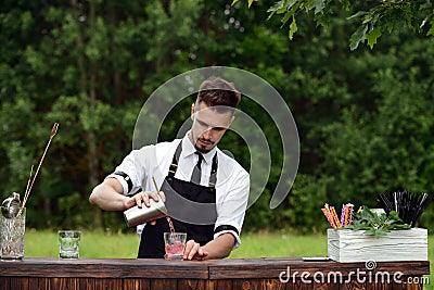 Catering bar service, bartender workplace. Handsome caucasian ba Stock Photo