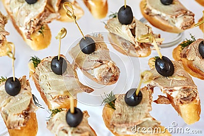 Catering of canape with olives, baguette and meat Stock Photo