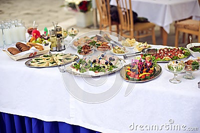 Catering service. Restaurant table with food. Huge amount of on the . Plates . Dinner time.