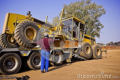 Caterpillar 140H Transporter - On Flatbed Trailer Stock Photo