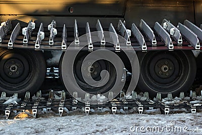 Caterpillar spikes on snowmobile in ski resort. Machine wheels with spikes for winter off road, extreme conditions. Tracked quad Stock Photo