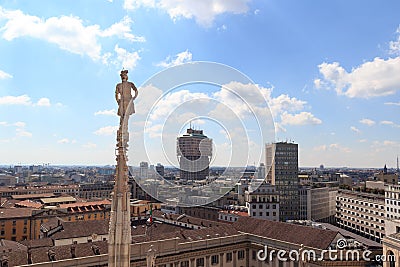 Cathedral statue and view of Milan cityscape with Torre Valesca Stock Photo