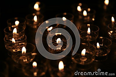 Catholic candles and glass candlesticks Stock Photo