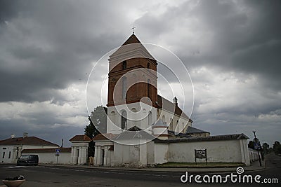 Catholic church in the city of Mir against the backdrop of a stormy sky. June. Evening. Stone building. Architecura. Story. Sight. Stock Photo