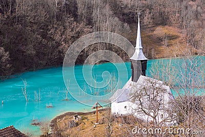 Catholic church and drowned cemetery. Waste lake with cyanide po Stock Photo