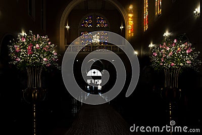 Catholic church during religious wedding ceremony - groom entering his mother Stock Photo