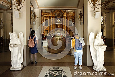 Catholic devotees pray to religious images and statues inside the Antipolo Cathedral Editorial Stock Photo