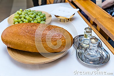 Catholic Holy Mass - Festive sacrificial gifts - bread and grapes Stock Photo