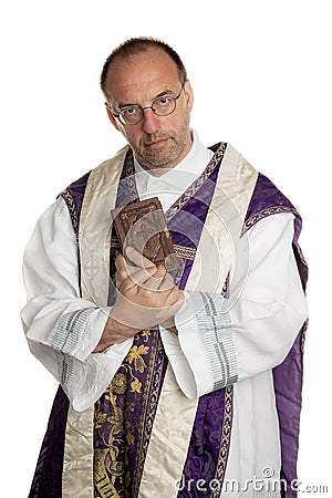 Catholic Priest with Bible in church Stock Photo
