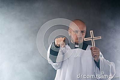 Catholic priest exorcist in white surplice and black shirt Stock Photo